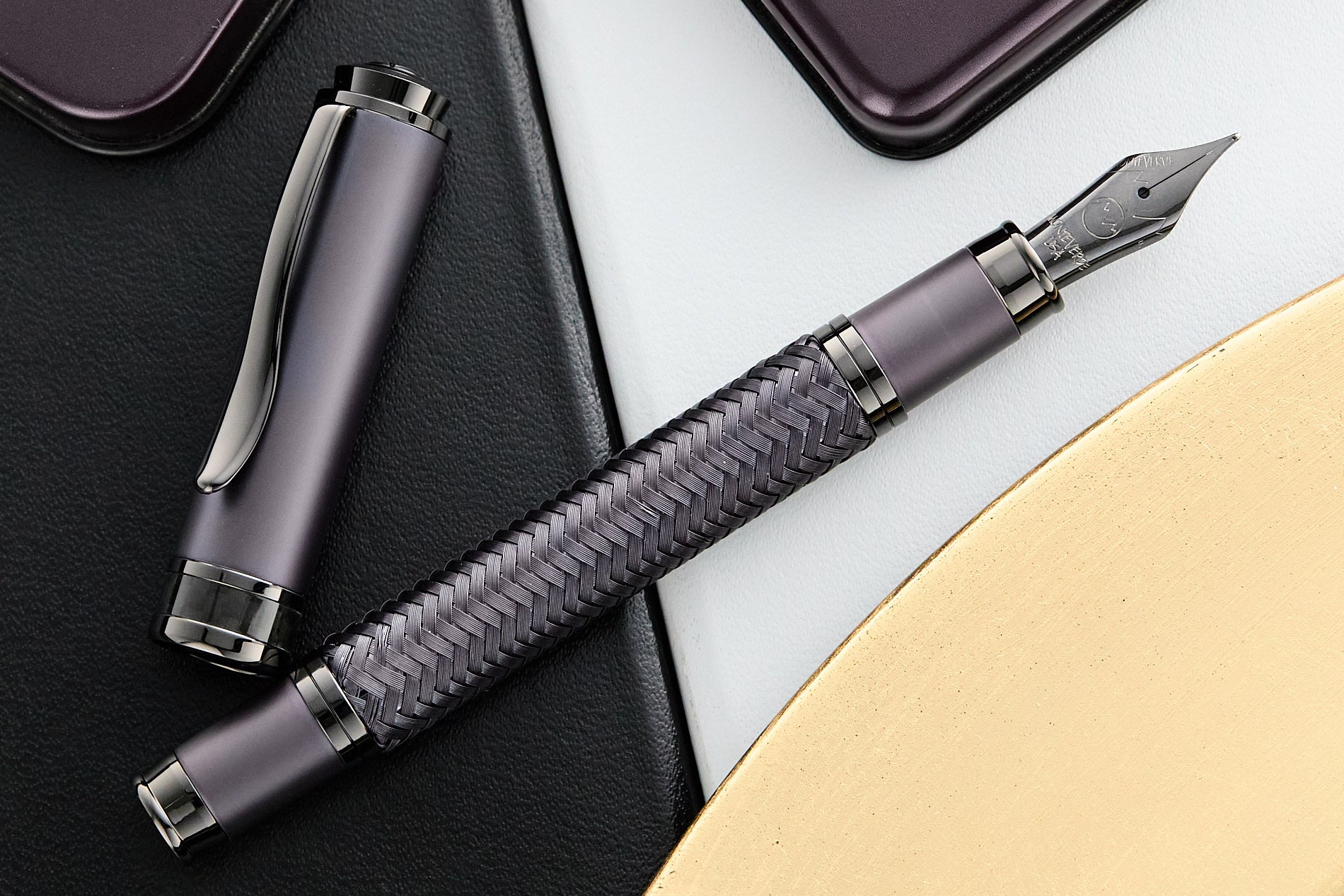 Monteverde Innova Formula M in Smoky Purple fountain pen uncapped on a desk with notebook and paper